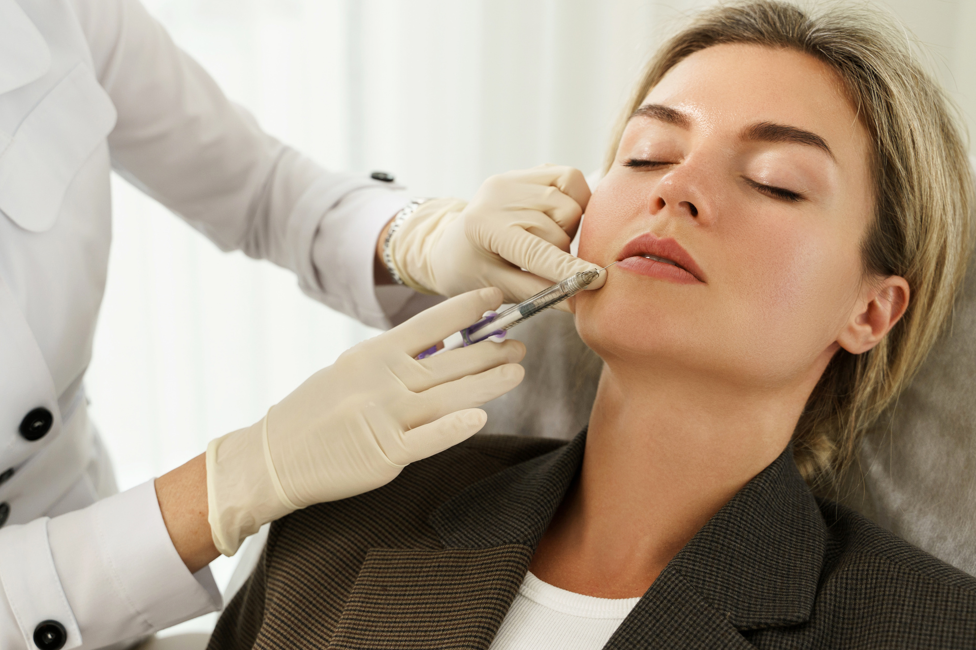 Woman during Facial Filler Injections in Aesthetic Medical Clini